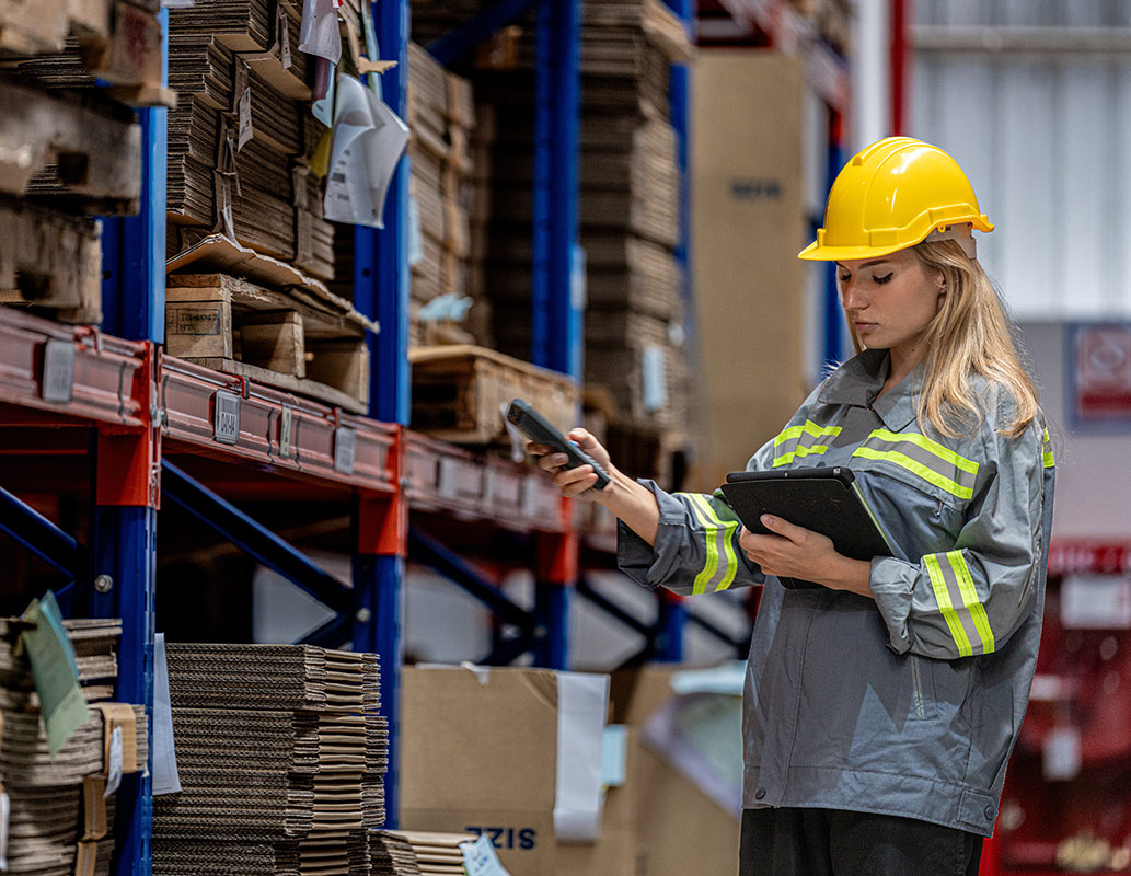 woman worker walking and checking stock items for shipping. Fema